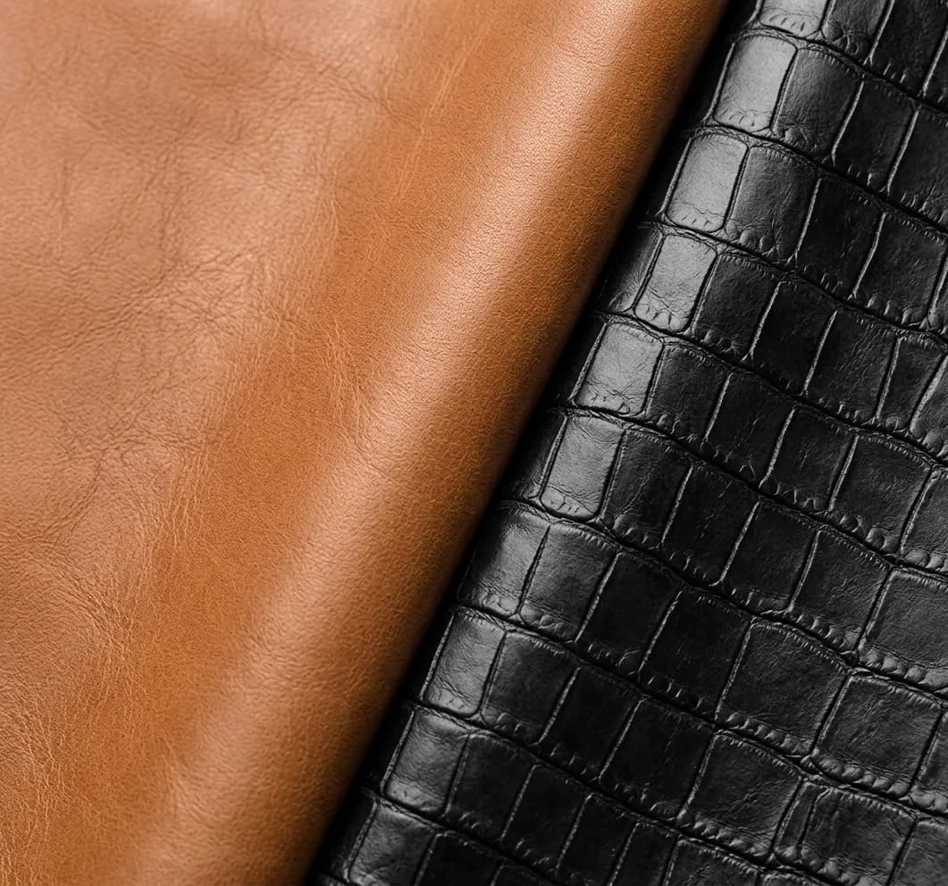 Macro shot of smooth tan lambskin and black crocodile-embossed leather